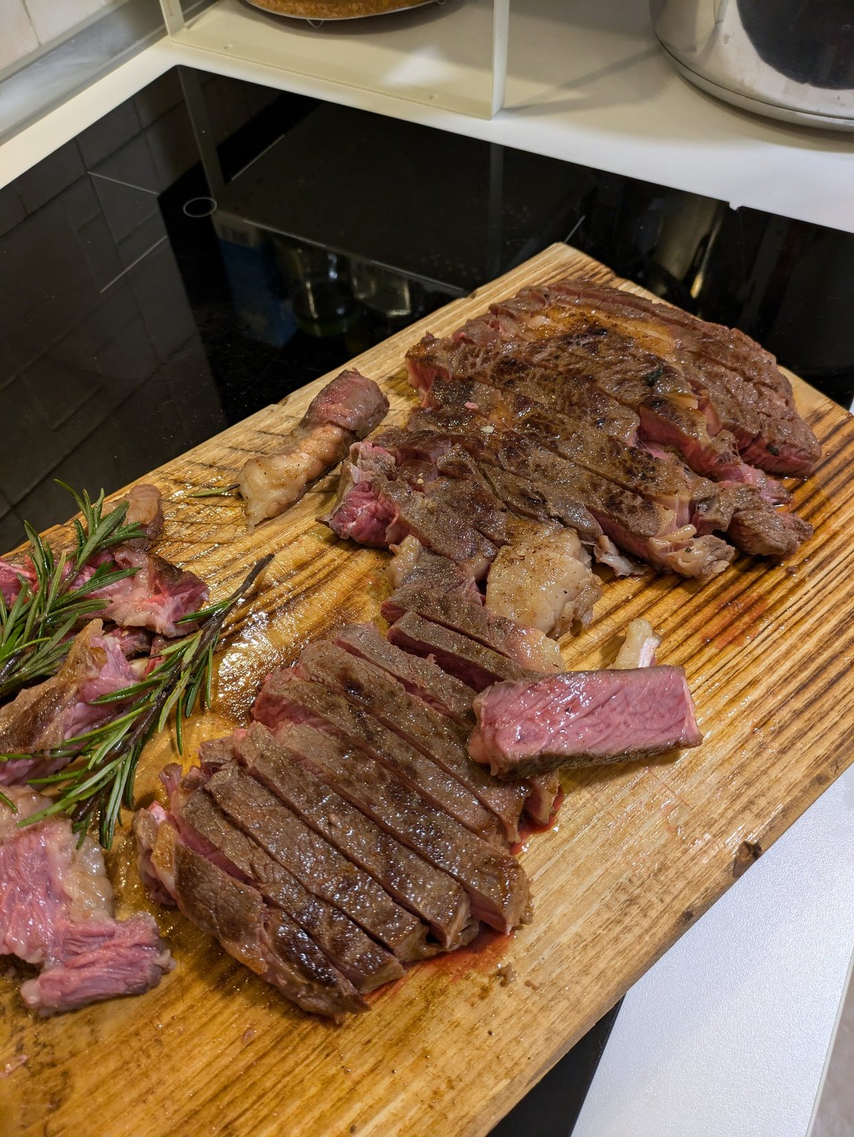 Portrait of a man with brown hair and glasses on a flat gray background.