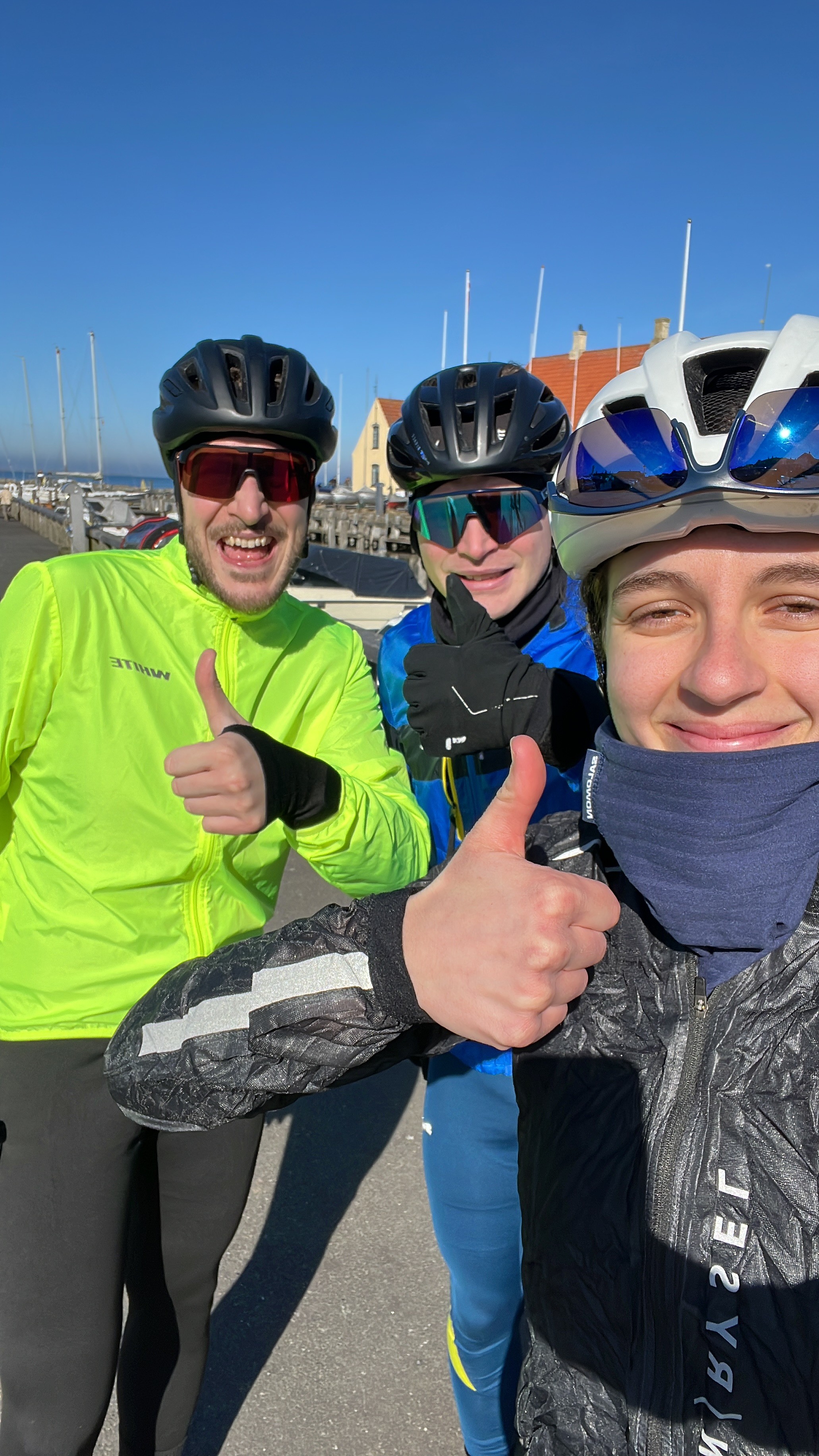 Portrait of a man with brown hair and glasses on a flat gray background.
