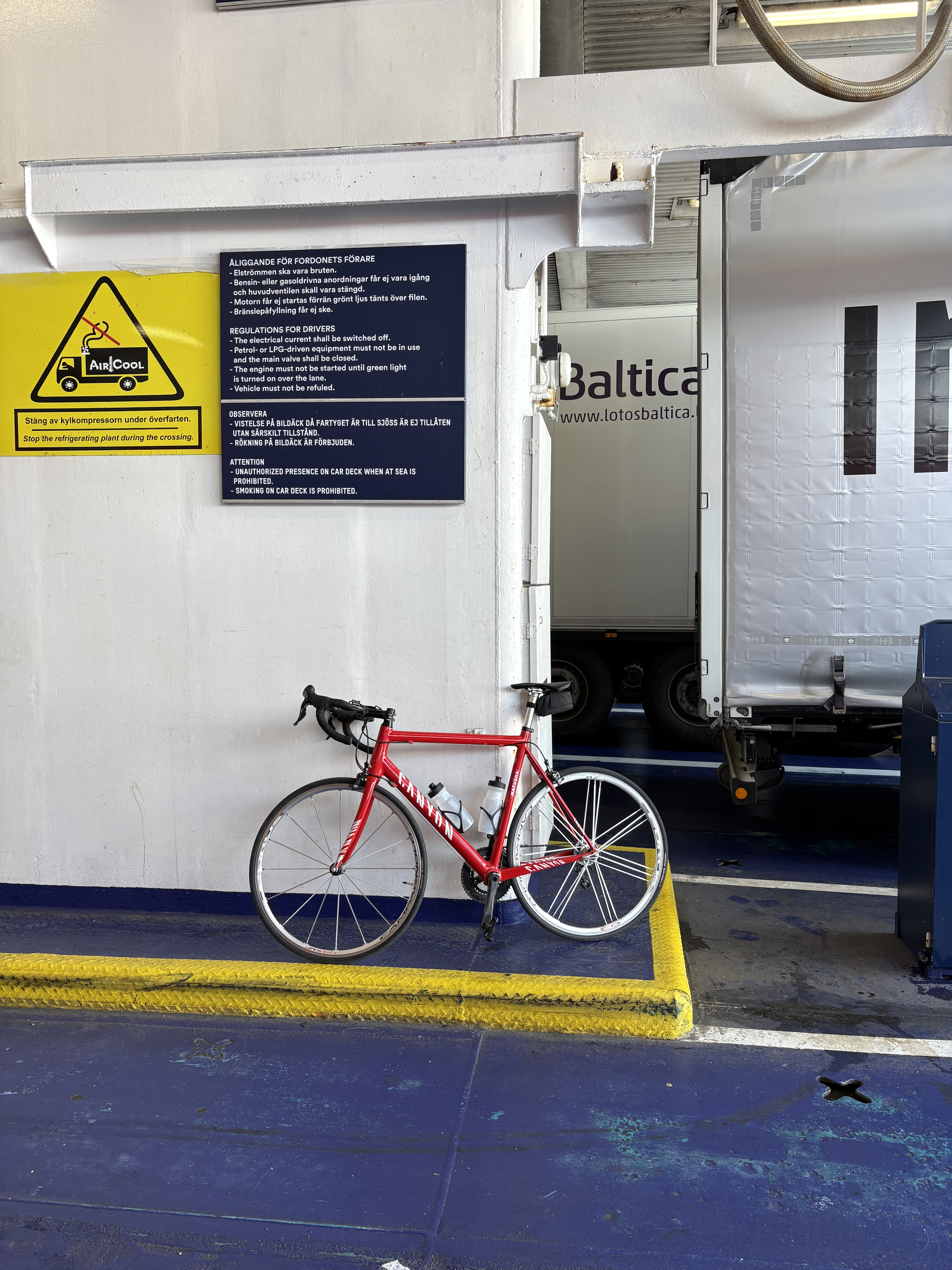 Portrait of a man with brown hair and glasses on a flat gray background.