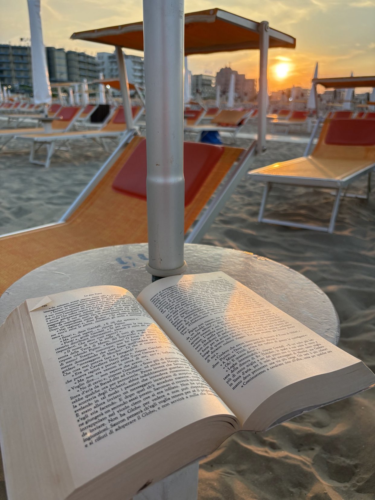 Portrait of a man with brown hair and glasses on a flat gray background.