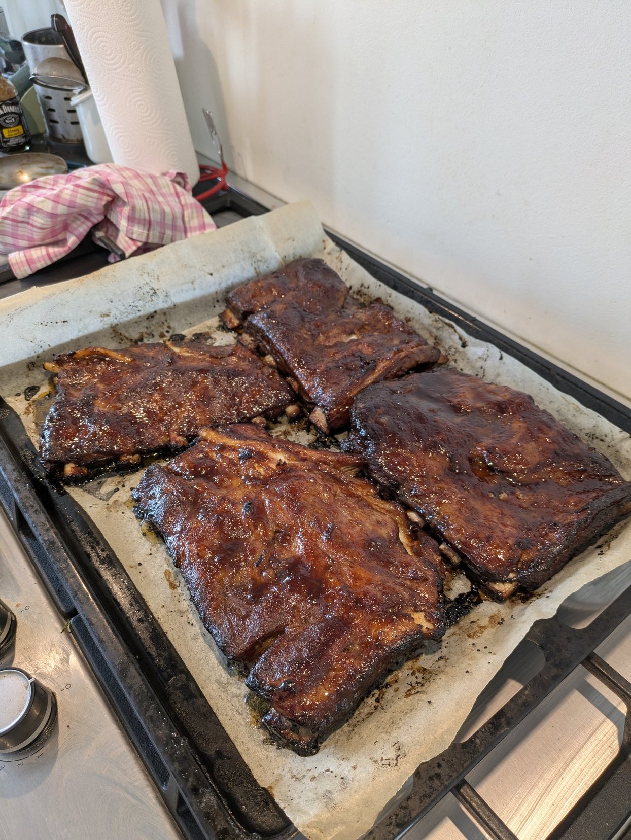 Portrait of a man with brown hair and glasses on a flat gray background.